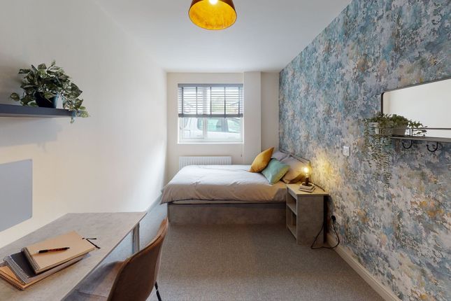 Bright And Stylish Bedroom Featuring A Comfortable...