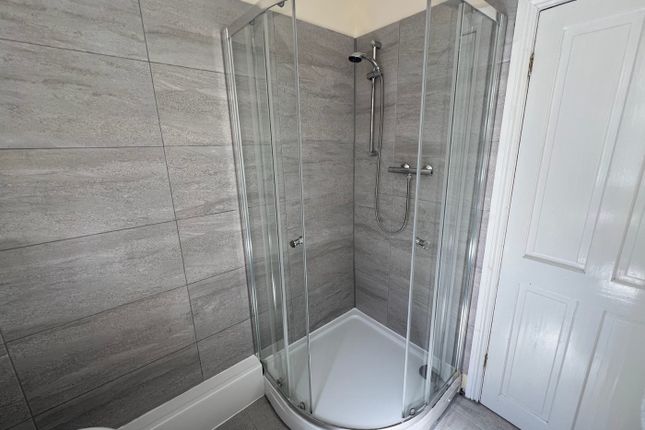 A Modern And Clean Bathroom Featuring A Stylish Sh...