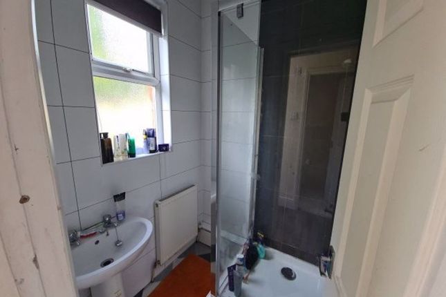 A Clean And Functional Bathroom Featuring A Bright...