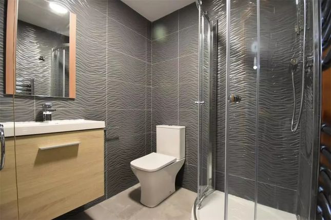 Modern Bathroom Featuring Textured Grey Tiles, A G...
