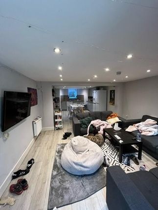 A Spacious And Modern Living Room Featuring A Larg...