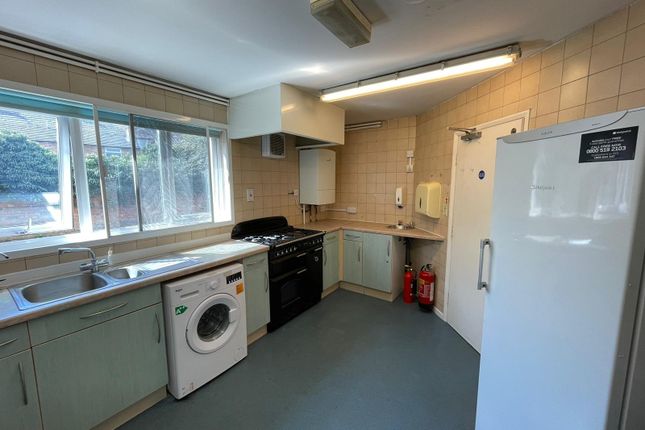 Bright And Functional Kitchen Featuring Ample Coun...