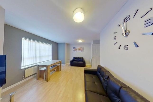 A Bright And Spacious Living Room Featuring Modern...