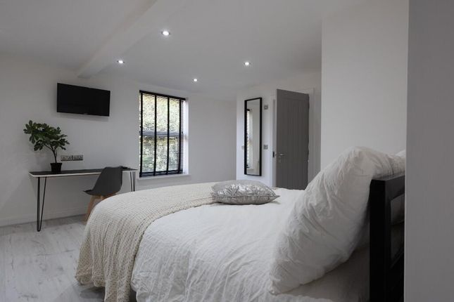 Bright And Welcoming Bedroom Featuring A Comfortab...