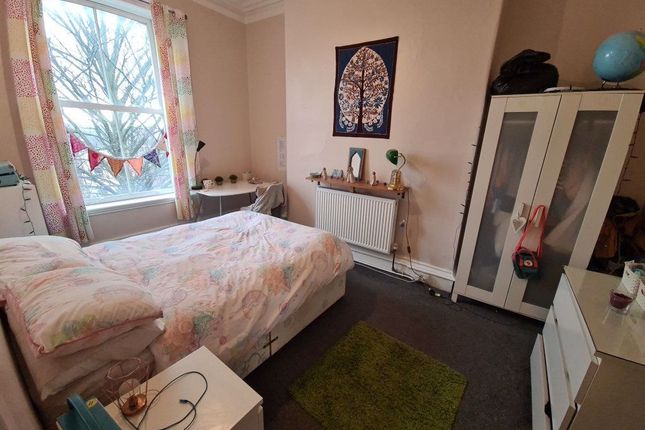 A Cozy Double Bedroom Featuring A Large Window Wit...