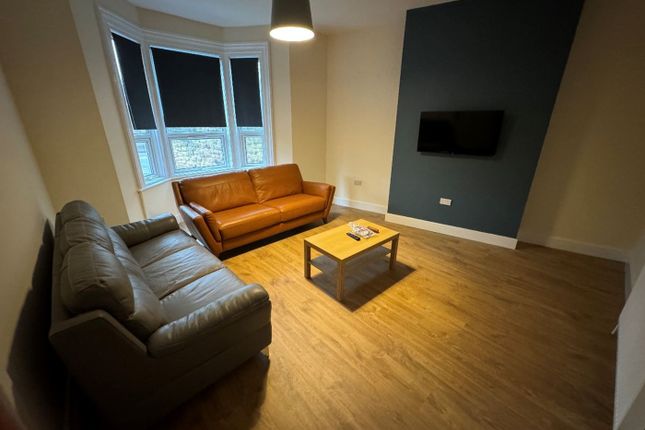 A Stylish And Inviting Living Room Featuring A Com...