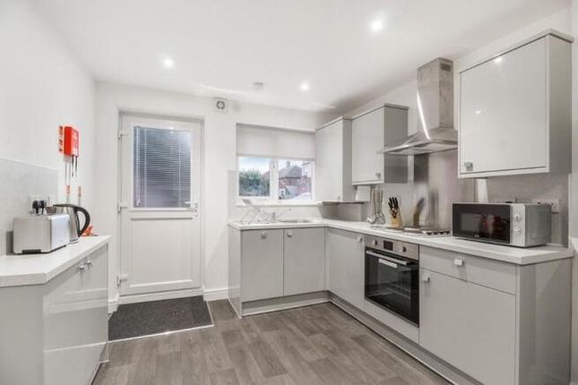 Bright And Modern Kitchen Featuring Sleek Grey Cab...