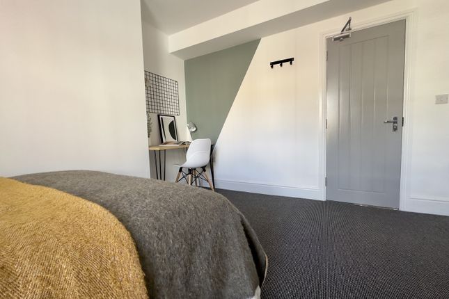 A Bright And Tidy Double Bedroom Featuring A Dedic...