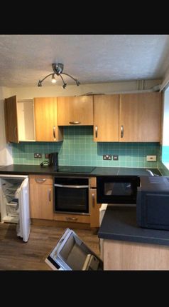 Spacious Kitchen Featuring Modern Wooden Cabinetry...