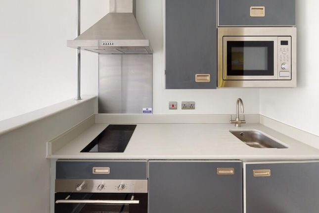 Modern Kitchen Featuring Sleek Grey Cabinetry, Int...