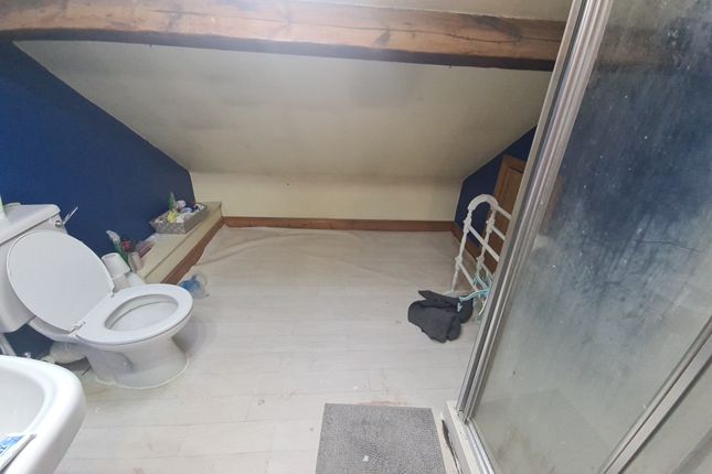 A Bathroom Featuring A Shower Enclosure And A Toil...