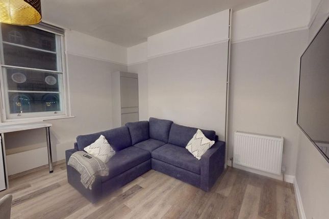 A Bright And Inviting Living Room, Perfect For Rel...