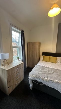 A Cozy Double Bedroom Featuring A Comfortable Bed ...