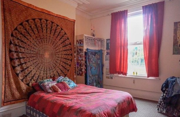 A Cozy Bedroom Featuring A Large Bed With Colorful...