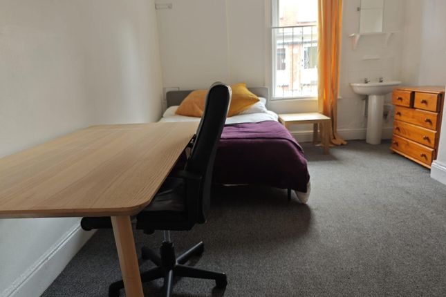 A Cozy Single Bedroom Featuring A Neatly Made Bed ...