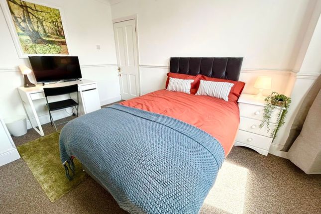 A Cozy Double Bedroom Featuring A Comfortable Bed ...