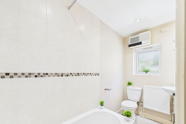 Bright And Clean Bathroom Featuring A Bathtub With...