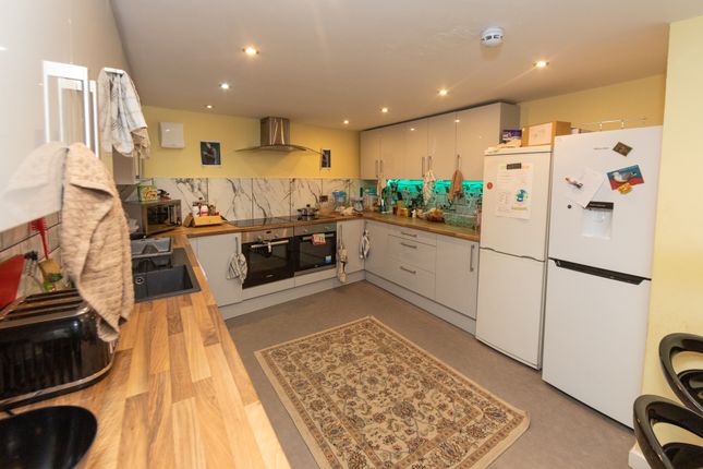 A Modern And Well-Equipped Kitchen Featuring White...