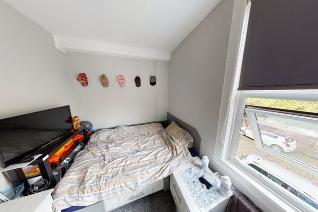 A Cozy Bedroom With A Bed Placed Next To A Window ...