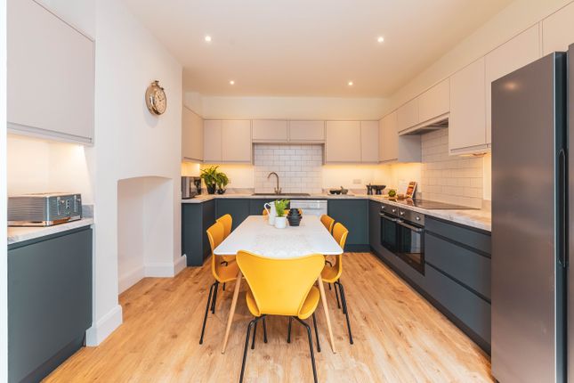 A Modern And Bright Kitchen Featuring Ample Space ...