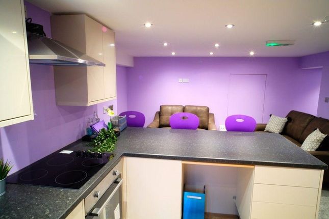 A Modern Kitchen With Purple Walls, Equipped With ...