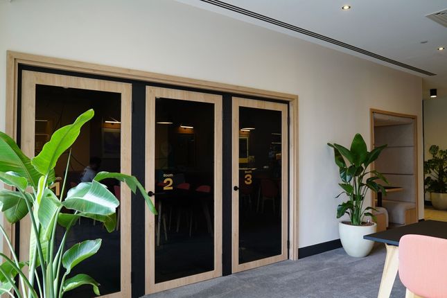 Modern Communal Workspace Featuring Private Booths...