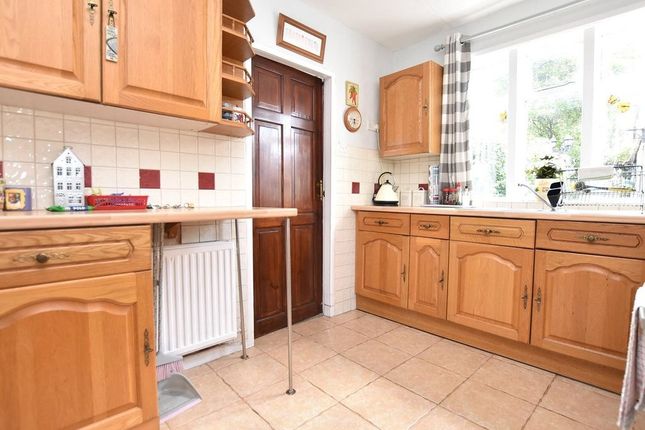 A Bright And Tidy Kitchen With Natural Light Strea...