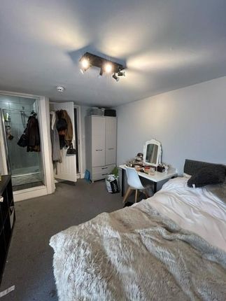 A Cozy Bedroom Featuring A Comfortable Bed With A ...