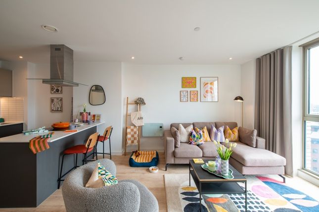 Bright And Stylish Living Room Featuring A Comfort...