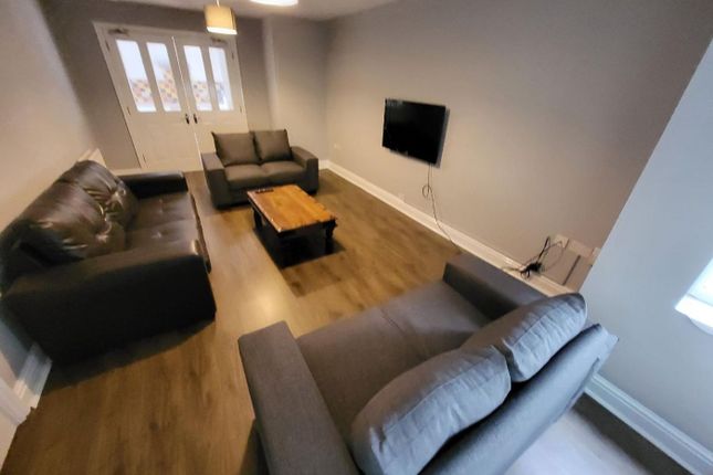 Spacious And Inviting Living Room Featuring Comfor...