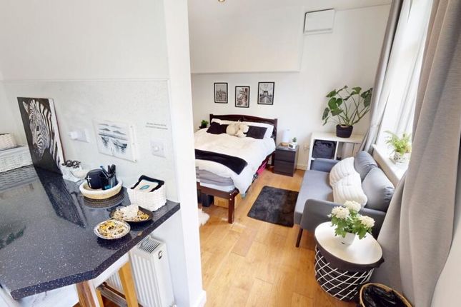 A Bright And Stylish Master Bedroom Featuring A Co...