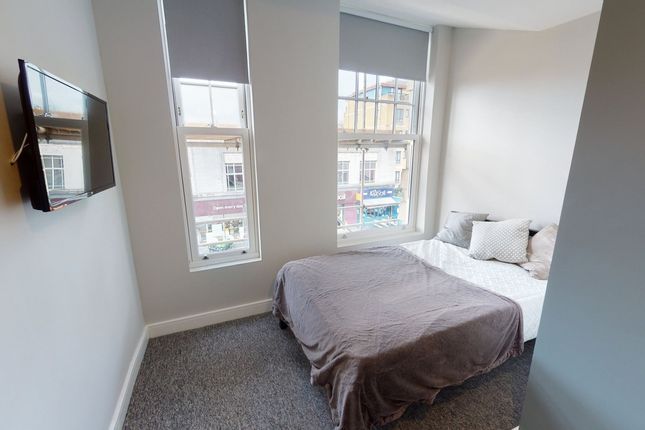 A Bright And Inviting Double Bedroom Featuring Lar...