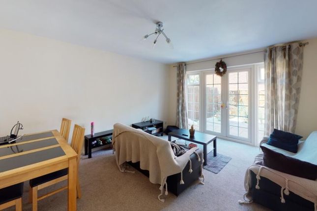 Bright And Inviting Living Room Featuring A Comfor...