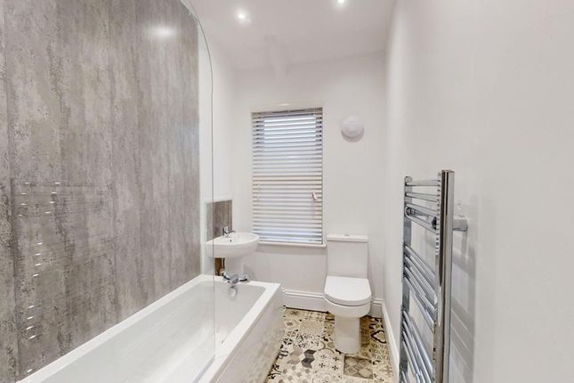 A Modern And Clean Bathroom Featuring A Stylish Ba...