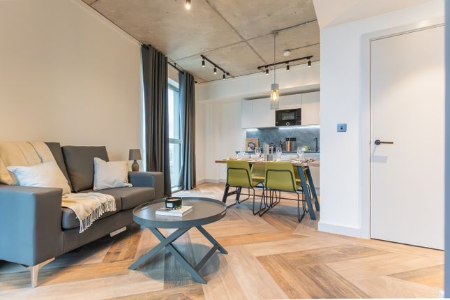A Spacious And Stylish Living Room With Modern Dec...