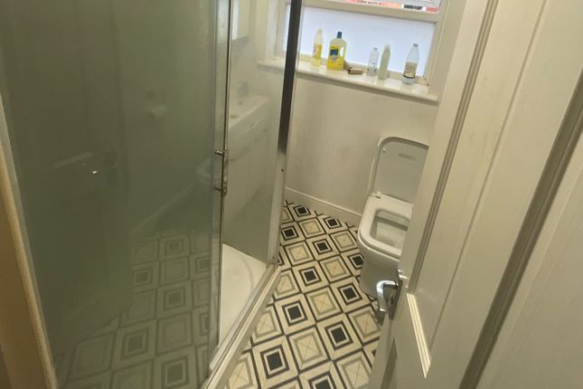 A Compact Bathroom Featuring A Walk-In Shower With...