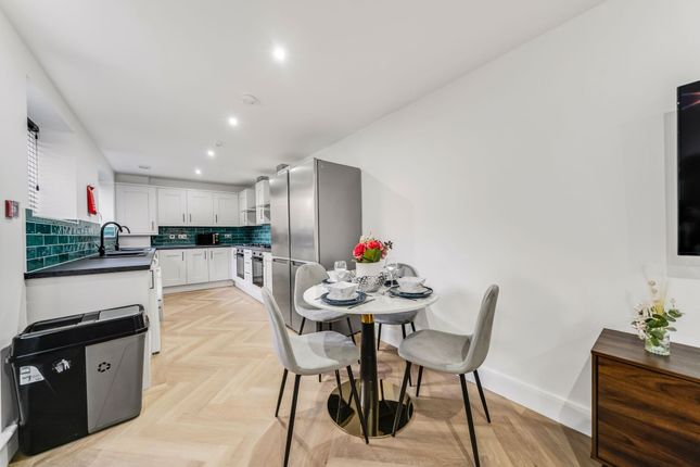 Modern And Bright Kitchen With White Cabinets, A S...
