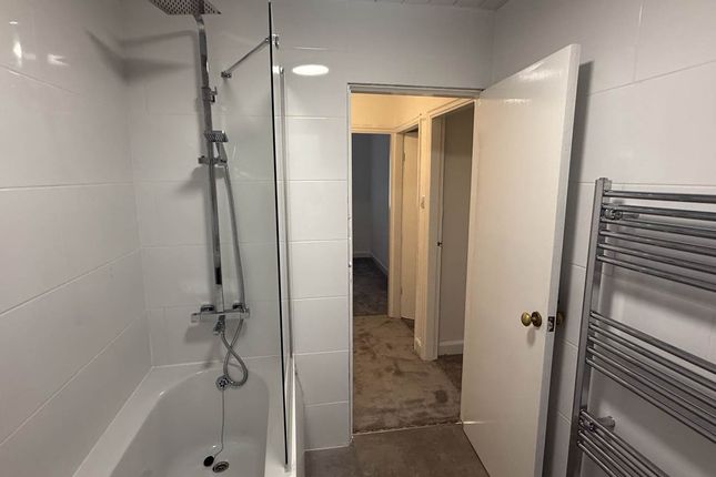 A Clean And Modern Bathroom With A Spacious Shower...