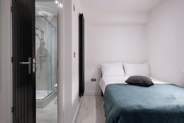 A Bright And Tidy Bedroom Featuring A Double Bed W...