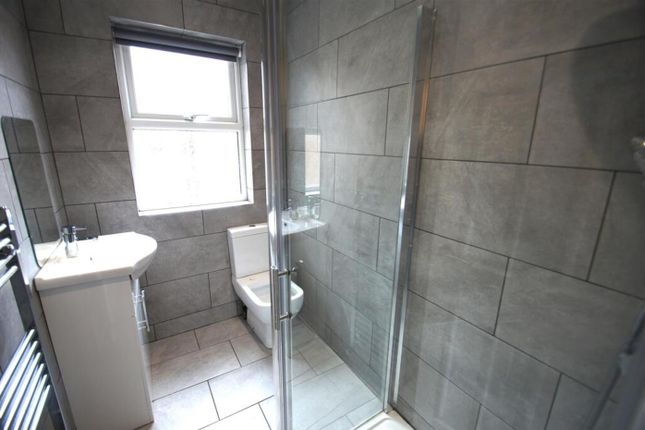 A Modern Bathroom Featuring Sleek Tiles And A Spac...