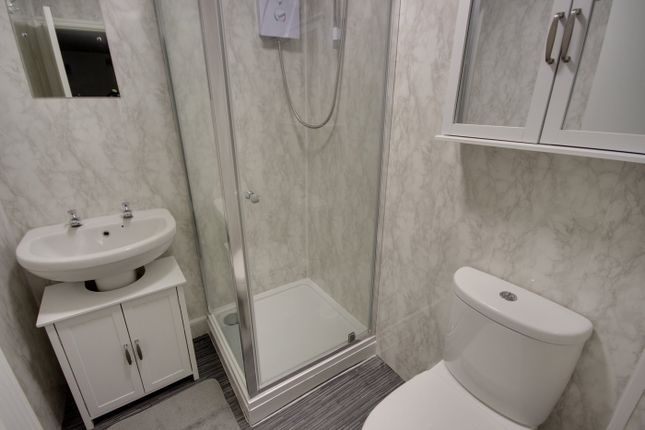 A Pristine And Modern Bathroom Featuring A Spaciou...