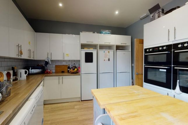 Spacious And Modern Kitchen Featuring Ample Storag...