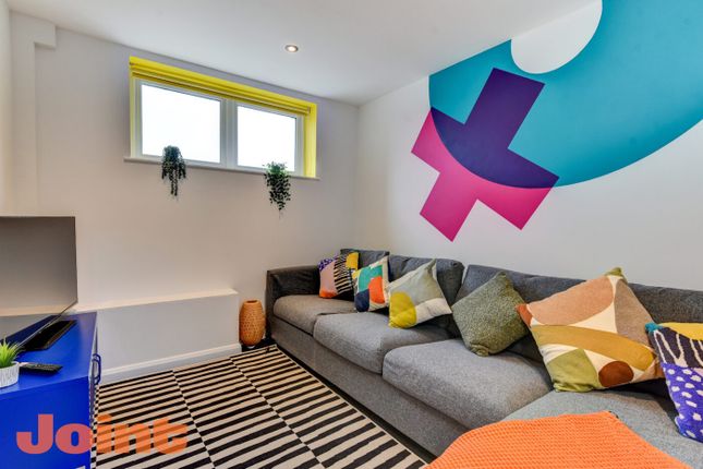 Modern And Vibrant Living Room Featuring A Spaciou...