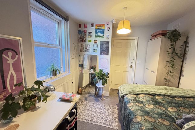 A Spacious And Well-Lit Bedroom Featuring A Large ...