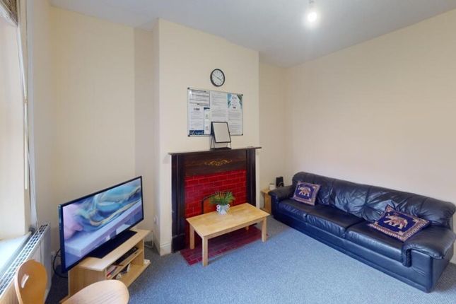 A Cozy Living Room Featuring A Comfortable Leather...