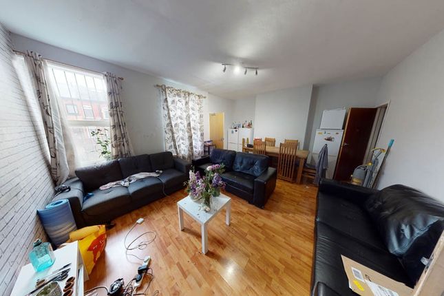 Bright, Well-Furnished Living Room With Large Wind...