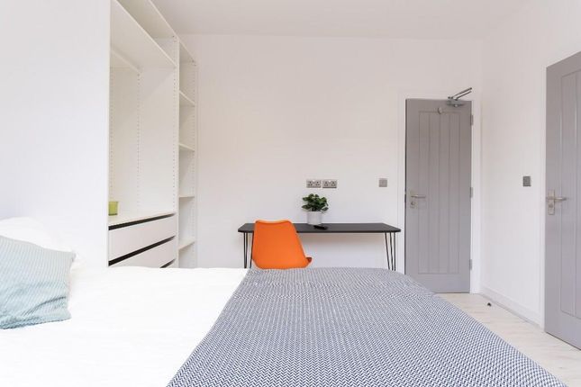 A Well-Maintained Student Bedroom Featuring A Comf...