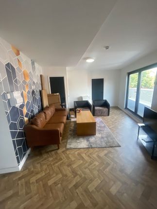 A Modern Living Room Featuring A Stylish Brown Lea...