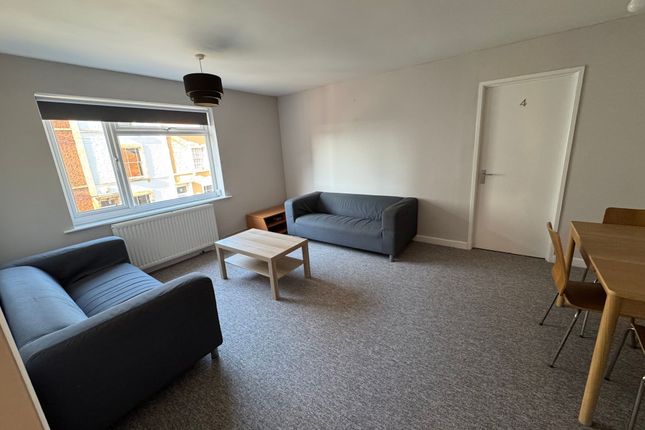 Bright And Spacious Living Room Featuring Two Comf...