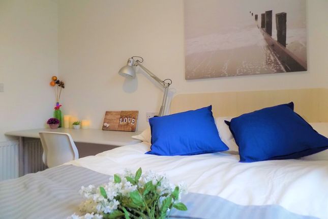 A Cozy Double Bedroom Featuring A Neatly Made Bed ...